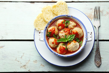 Meat balls with tomato sauce, on wooden background