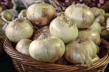Yellow onions in a wicker basket