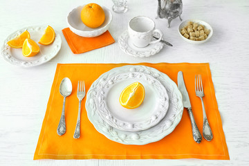 Table setting with orange napkin