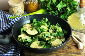 Sliced zucchini in pan on table, closeup
