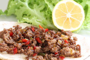 healthy eating: grilled beef taco with vegetables, salad and lemon served on plate
