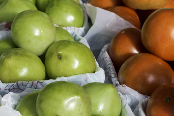Green and Red Tomatoes on display at a farmers' market
