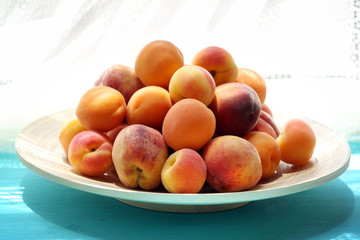 Heap of fresh fruits on windowsill