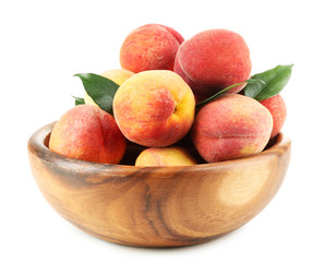 Ripe peaches in bowl isolated on white