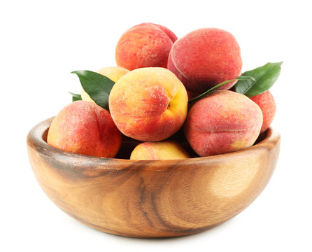 Ripe peaches in bowl isolated on white