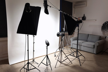 Empty photo studio with lighting equipment