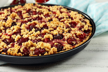 Tasty homemade pie with cherries on table close up