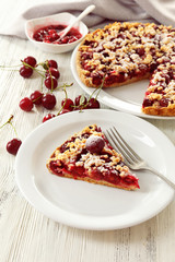 Tasty homemade pie with cherries on table close up