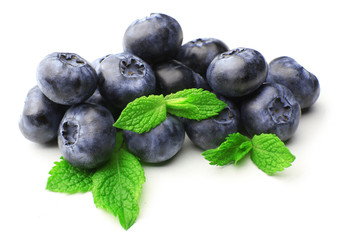Fresh blueberries with mint leaves isolated on white