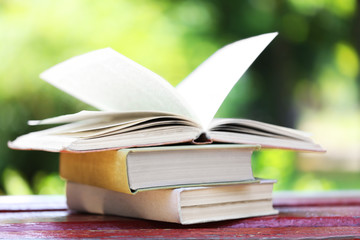 Stack of books outdoors, on blurred background