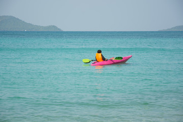 men paddle kayak on the sea