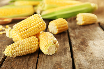 Fresh corn on cobs on rustic wooden table, closeup