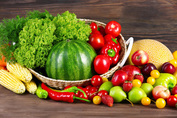 Composition with fresh fruits and vegetables on wooden background