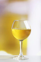 Glass of wine on light blurred background