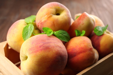 Fresh peaches in wooden crate, closeup
