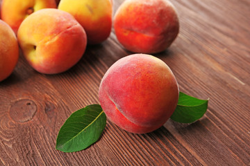 Fresh peaches on wooden table, closeup