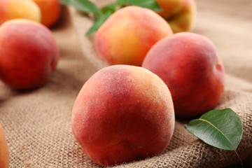 Fresh peaches on sackcloth, closeup