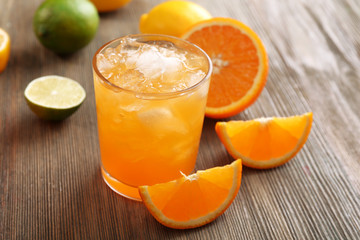 Naklejka na ściany i meble Glass of orange juice on wooden table, closeup