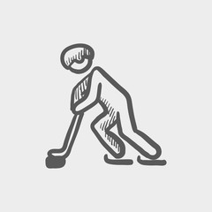 Hockey player pushing the puck sketch icon