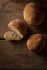 loaf of fresh bread on wooden background