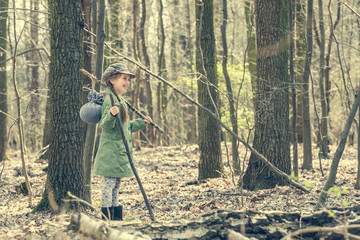 smiling little girl goes through the woods