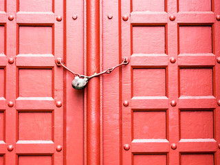 lock and chain on red door