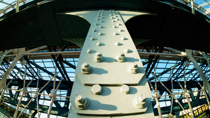 Details of metal bridge - rivets and beams in sunset light