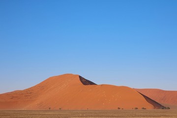 Fototapeta na wymiar Desert view of red dunes in Sossusvlei, Namibia