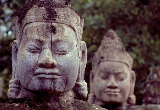 Carved stone statues aligned at South Gate to Angkor Thom, Angkor, Cambodia