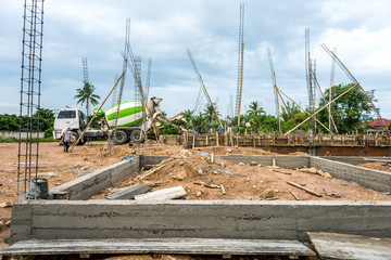 Workers pouring cement as a foundation for a new buildings