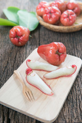 slice rose apple on wood plate