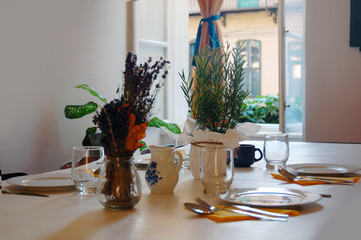beautiful summer room interior with table set for dinner, filled with sunlight