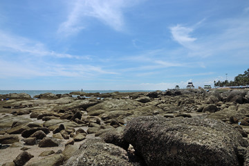 Fototapeta na wymiar Stones on the beach under blue sky