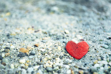 Heart shaped stone on the sand. Love concept