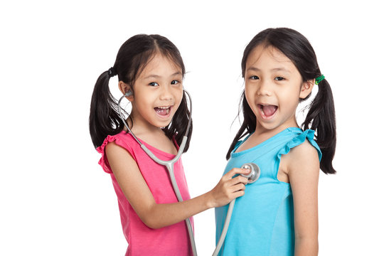 Happy Asian twins girls with stethoscope