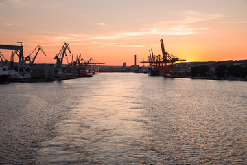Cranes working at the port of Gdansk over sunrise