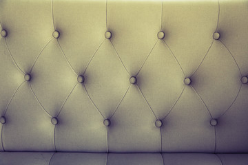brown couch background texture with sunken buttons.