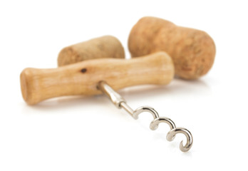corkscrew and wine cork on white