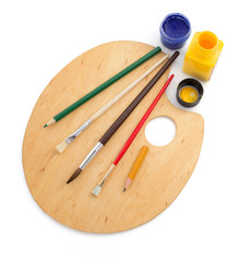 wooden palette and paintbrush on white