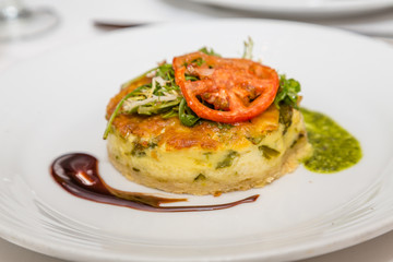 Individual Quiche with Tomato and Arugula.