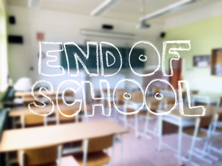 A chalk lettering with a blurred classroom