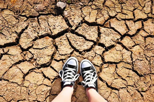 Girl standing on a dried earth