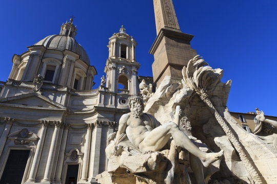 Fontana dei Quattro Fiumi, topped by the Obelisk of Domitian with the Sant'Agnese in Agone, Piazza Navona, Rome, Lazio