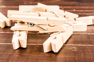 Wooden clothespins on wooden background