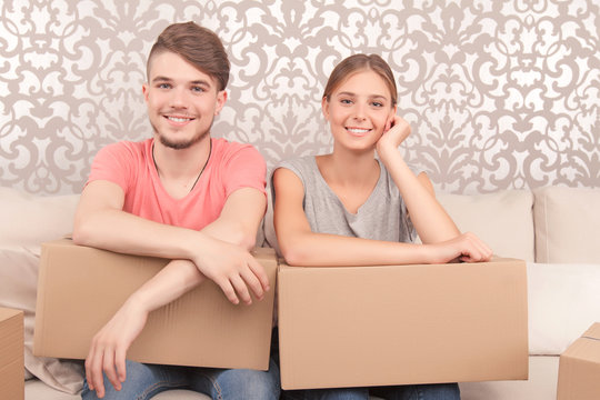 Cheerful couple holding boxes 