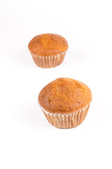 Two brown banana muffin in paper cupcake holder isolated on whit