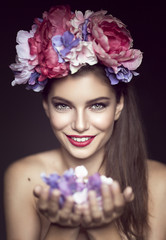 Attractive Young Happy Smiling Brunette holding Flowers - 88321824
