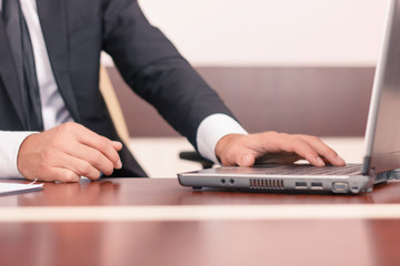 Handsome lawyer working on his laptop 