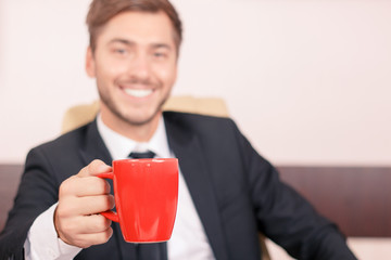 Smiling lawyer drinking tea 