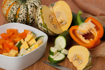 Organic Harlequin Squash. Zucchini. Paprika. Wooden Board